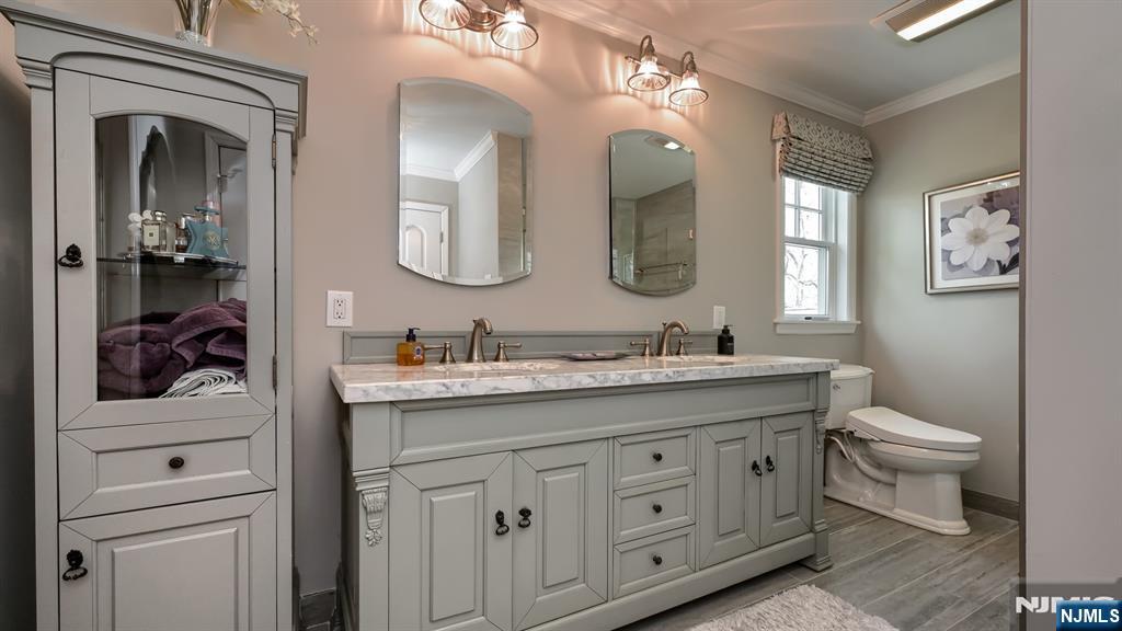 23 Erli Street Wayne, NJ 07470 - Photo 28 of 49 a bathroom with a toilet a sink and mirror