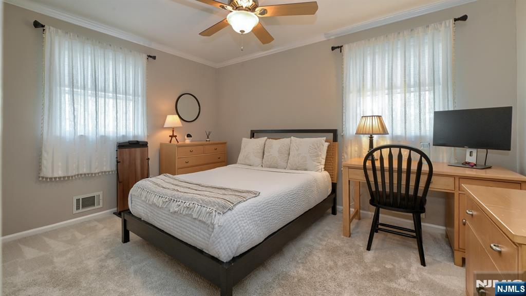 23 Erli Street Wayne, NJ 07470 - Photo 33 of 49 a bedroom with a bed and a chandelier
