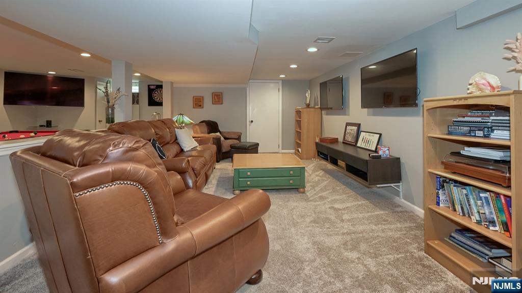 23 Erli Street Wayne, NJ 07470 - Photo 35 of 49 a living room with furniture and a flat screen tv