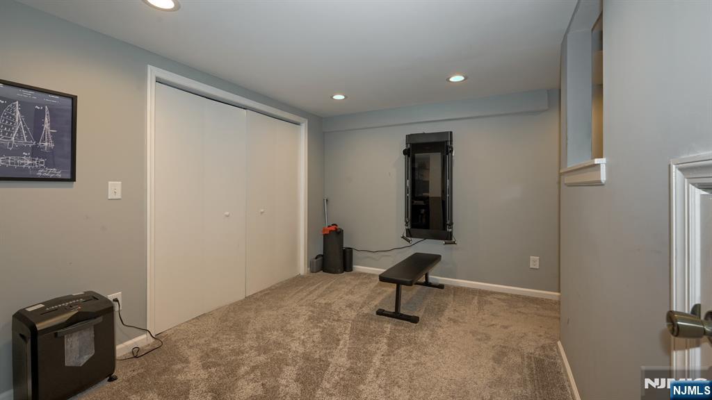 23 Erli Street Wayne, NJ 07470 - Photo 36 of 49 a view of a livingroom with a projector and furniture