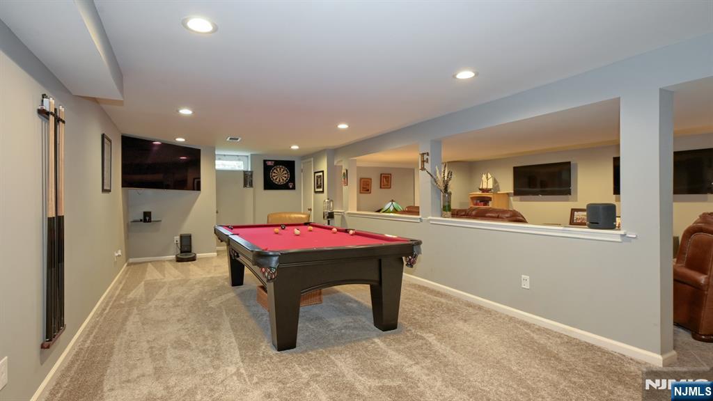 23 Erli Street Wayne, NJ 07470 - Photo 37 of 49 a room with furniture pool table flat screen tv and a refrigerator