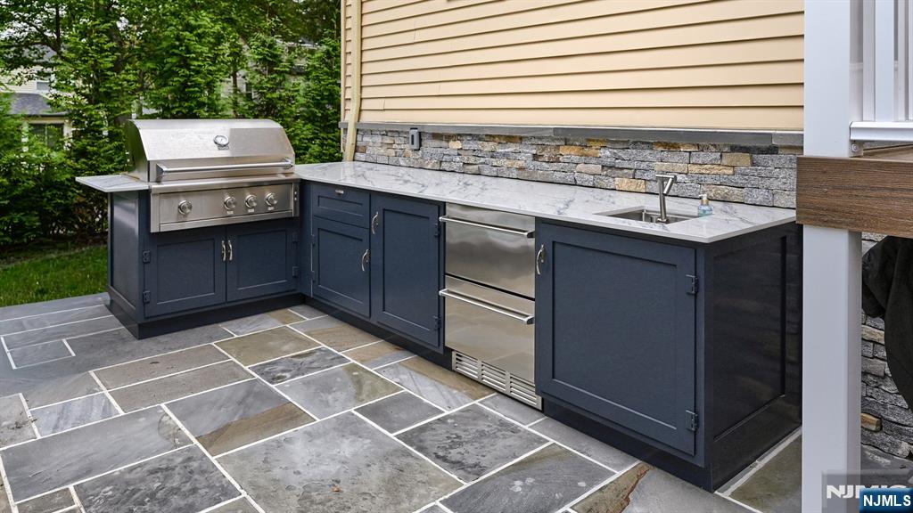 23 Erli Street Wayne, NJ 07470 - Photo 42 of 49 a stove top oven sitting inside of a kitchen