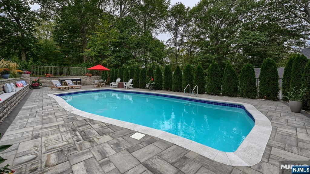 23 Erli Street Wayne, NJ 07470 - Photo 43 of 49 a view of a swimming pool with a patio