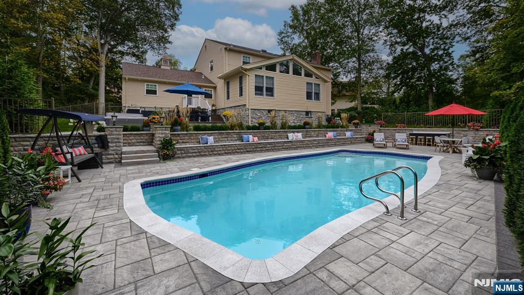23 Erli Street Wayne, NJ 07470 - Photo 44 of 49 a swimming pool with outdoor seating and yard