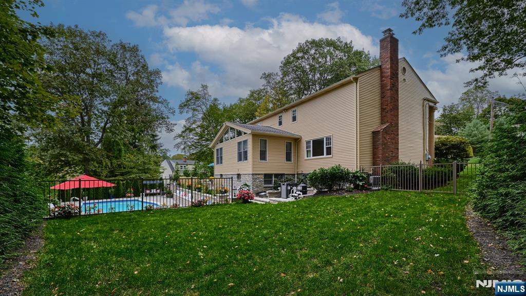 23 Erli Street Wayne, NJ 07470 - Photo 48 of 49 a front view of a house with a garden and trees