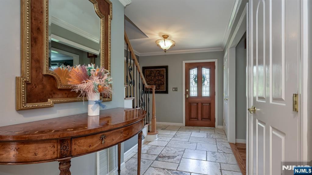 23 Erli Street Wayne, NJ 07470 - Photo 8 of 49 a hallway with dining area and chandelier