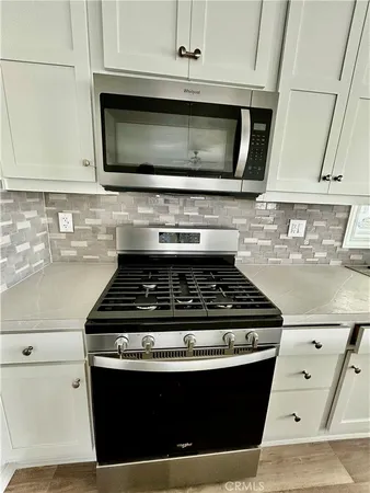 a stove top oven sitting inside of a kitchen