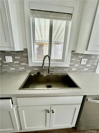 a sink a stove a microwave and cabinets