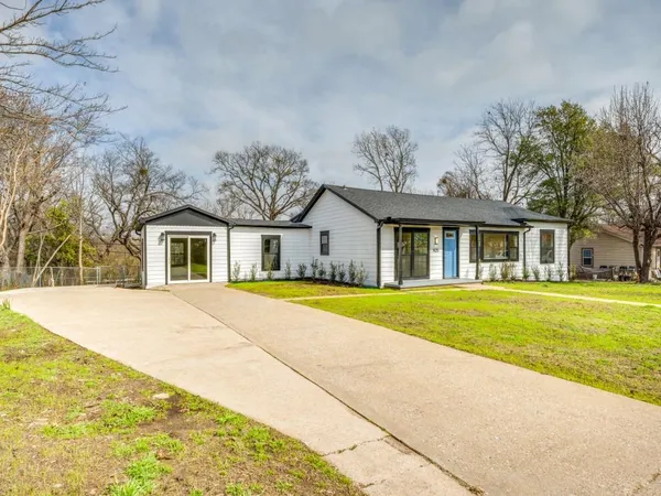 a house with swimming pool in front of it