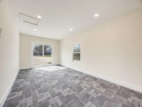 a view of empty room with a fireplace