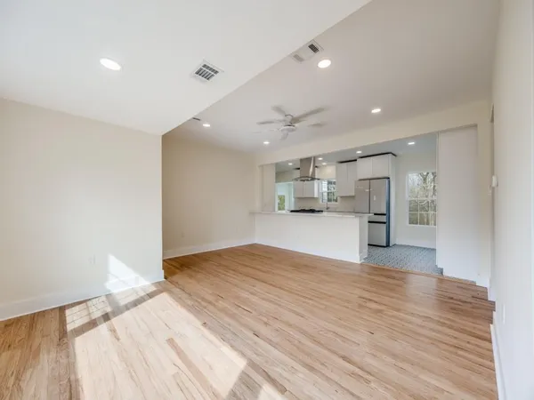 a view of empty room with wooden floor