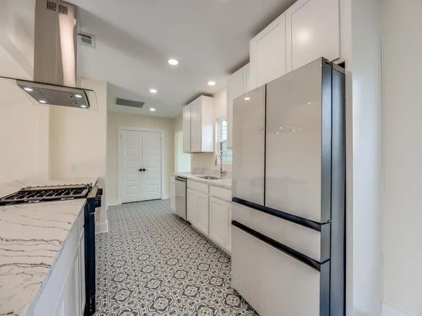 a kitchen with a refrigerator and a sink