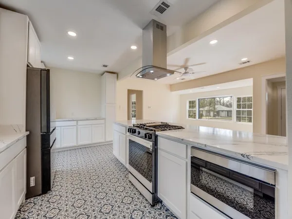 a kitchen with granite countertop a stove and a refrigerator