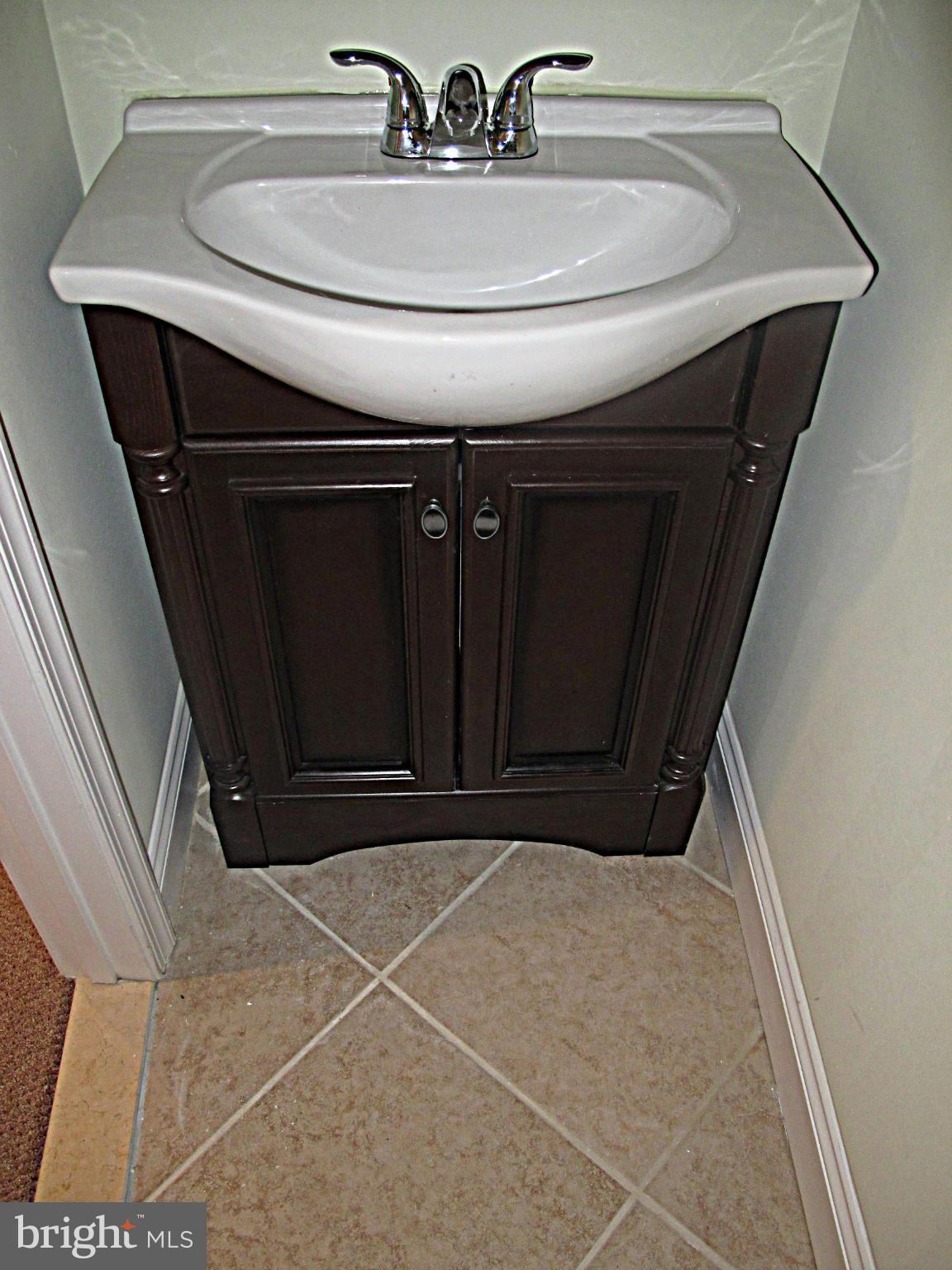 8910 Maplebrook Road Randallstown, MD 21133 - Photo 12 of 18 a bathroom with a sink and a mirror