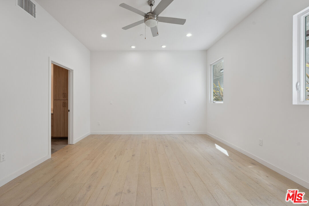 1746 Garfield Place, Unit 101 Los Angeles, CA 90028 - Photo 13 of 28 wooden floor in an empty room with a window