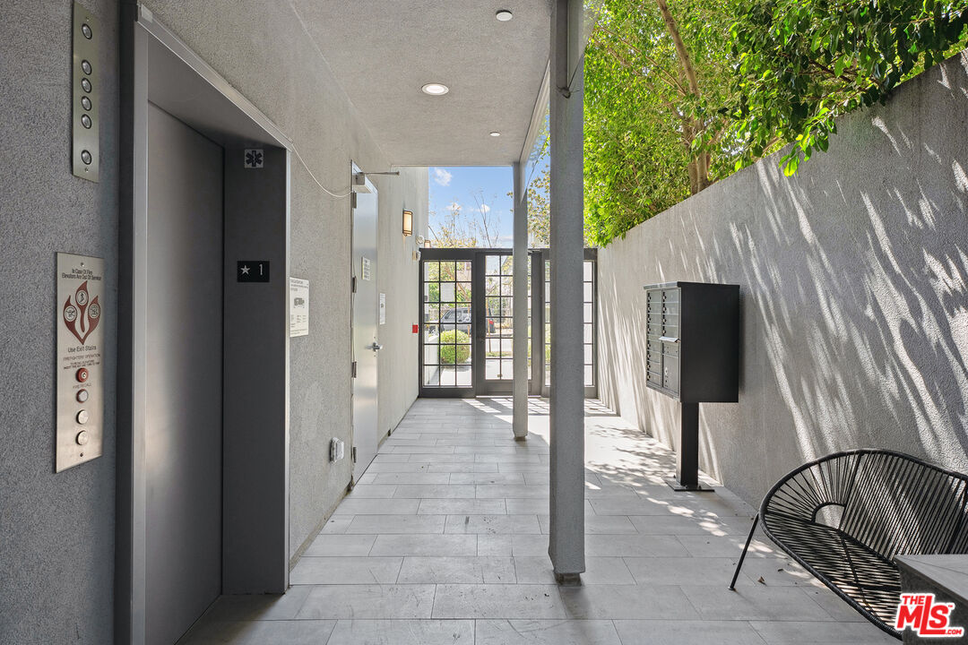 1746 Garfield Place, Unit 101 Los Angeles, CA 90028 - Photo 21 of 28 a view of a hallway with a couch and stairs