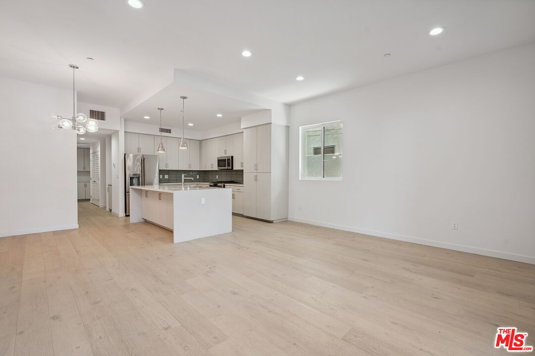 1746 Garfield Place, Unit 101 Los Angeles, CA 90028 - Photo 3 of 28 a view of kitchen with refrigerator and cabinets