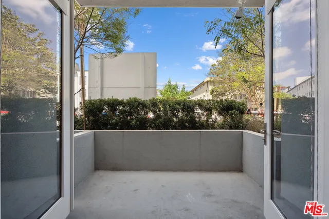 a kitchen with kitchen island white cabinets and stainless steel appliances