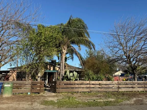 a view of a yard with yellow house
