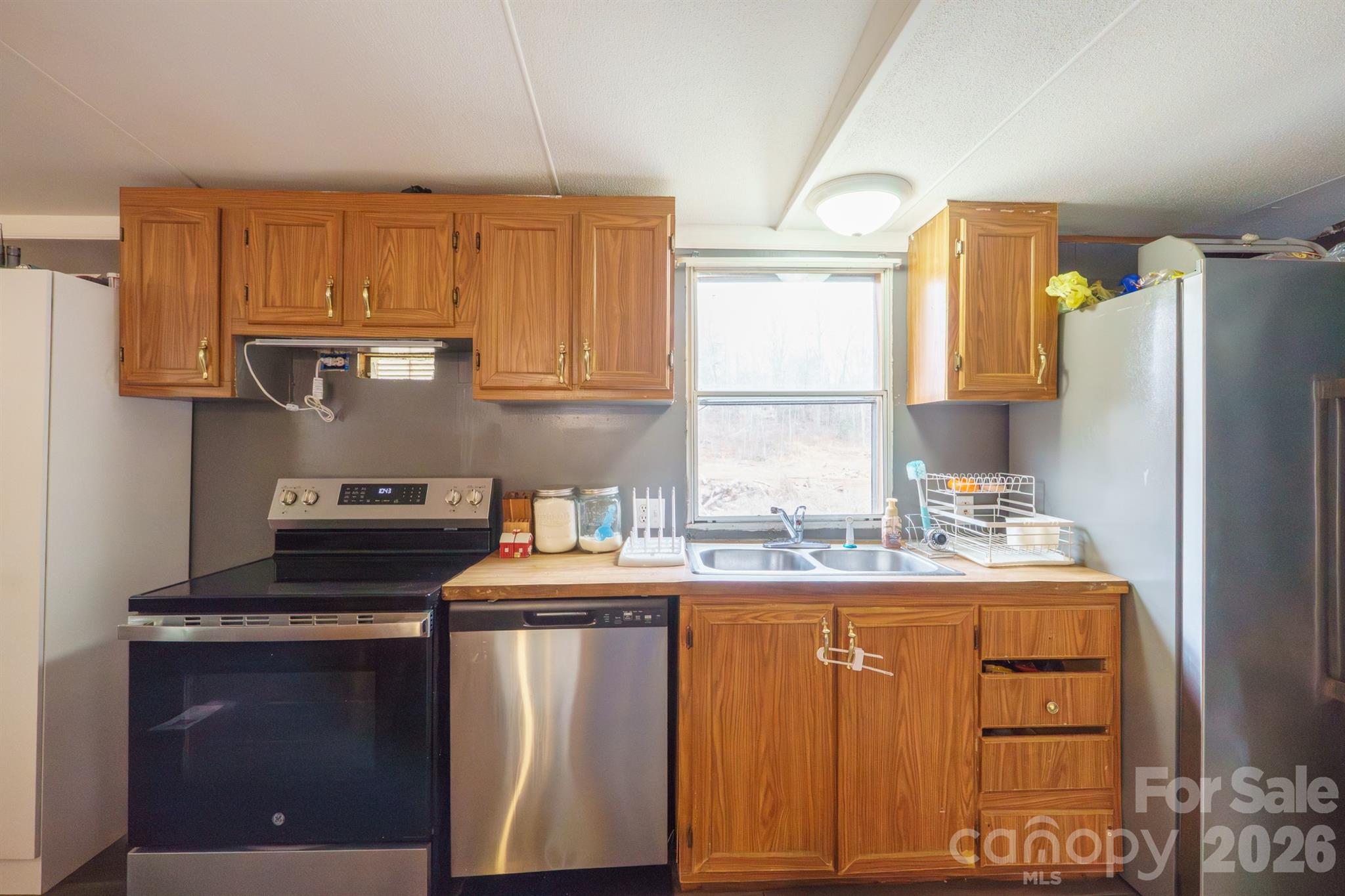 1775 Highway 70 Morganton, NC 28655 - Photo 9 of 18 a kitchen with stainless steel appliances granite countertop a sink stove and refrigerator