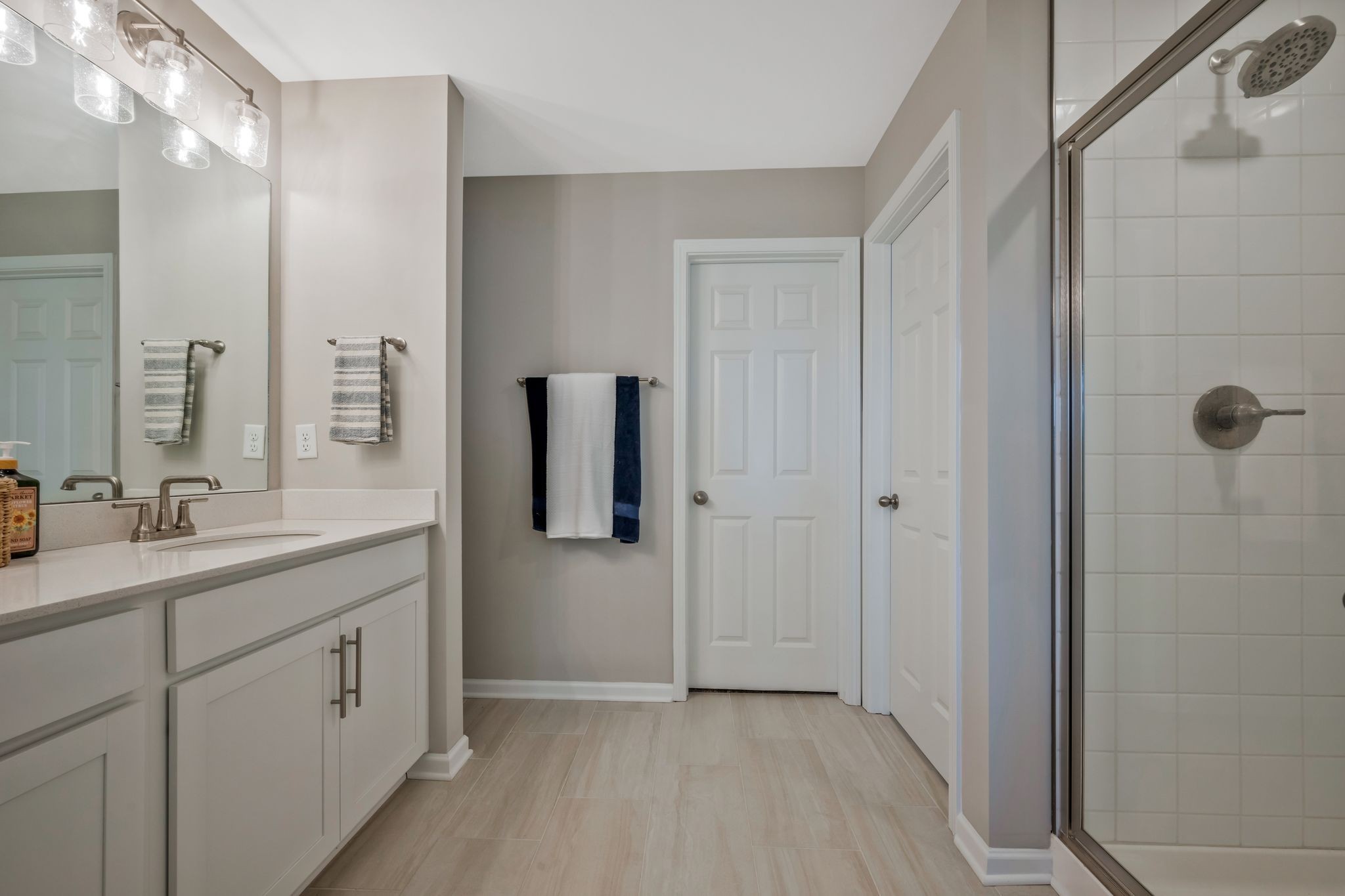 147 Timber Crest Trail White Bluff, TN 37187 - Photo 19 of 29 a spacious bathroom with a granite countertop sink a mirror and a shower