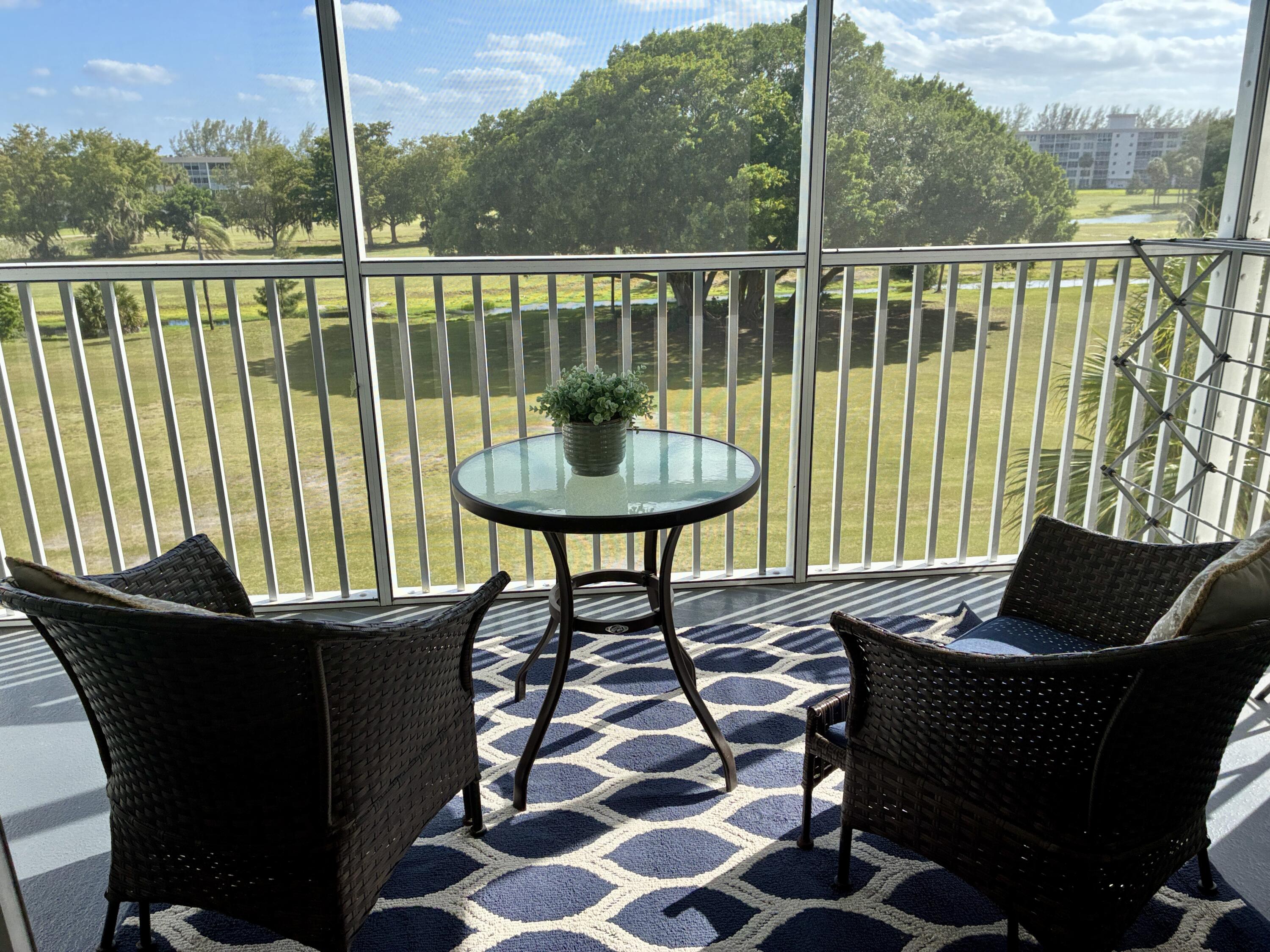 2691 South Course Drive, Unit 409 Pompano Beach, FL 33069 - Photo 1 of 22 a view of a balcony with chairs