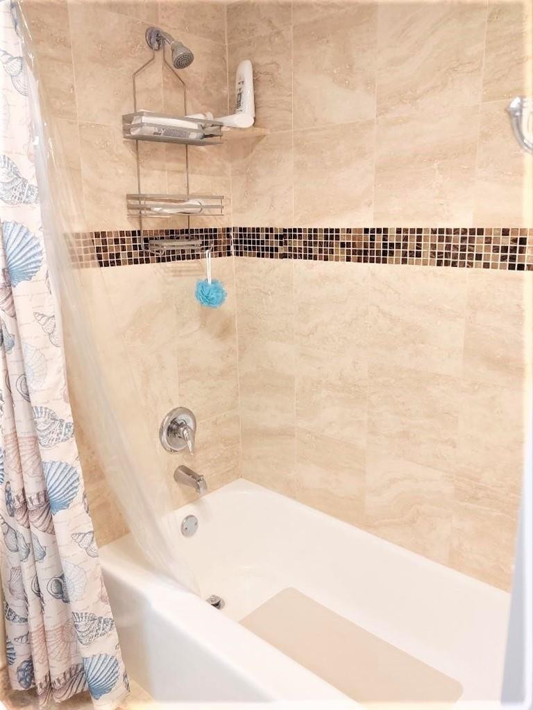 2691 South Course Drive, Unit 409 Pompano Beach, FL 33069 - Photo 12 of 22 a bathroom with a bathtub and a shower