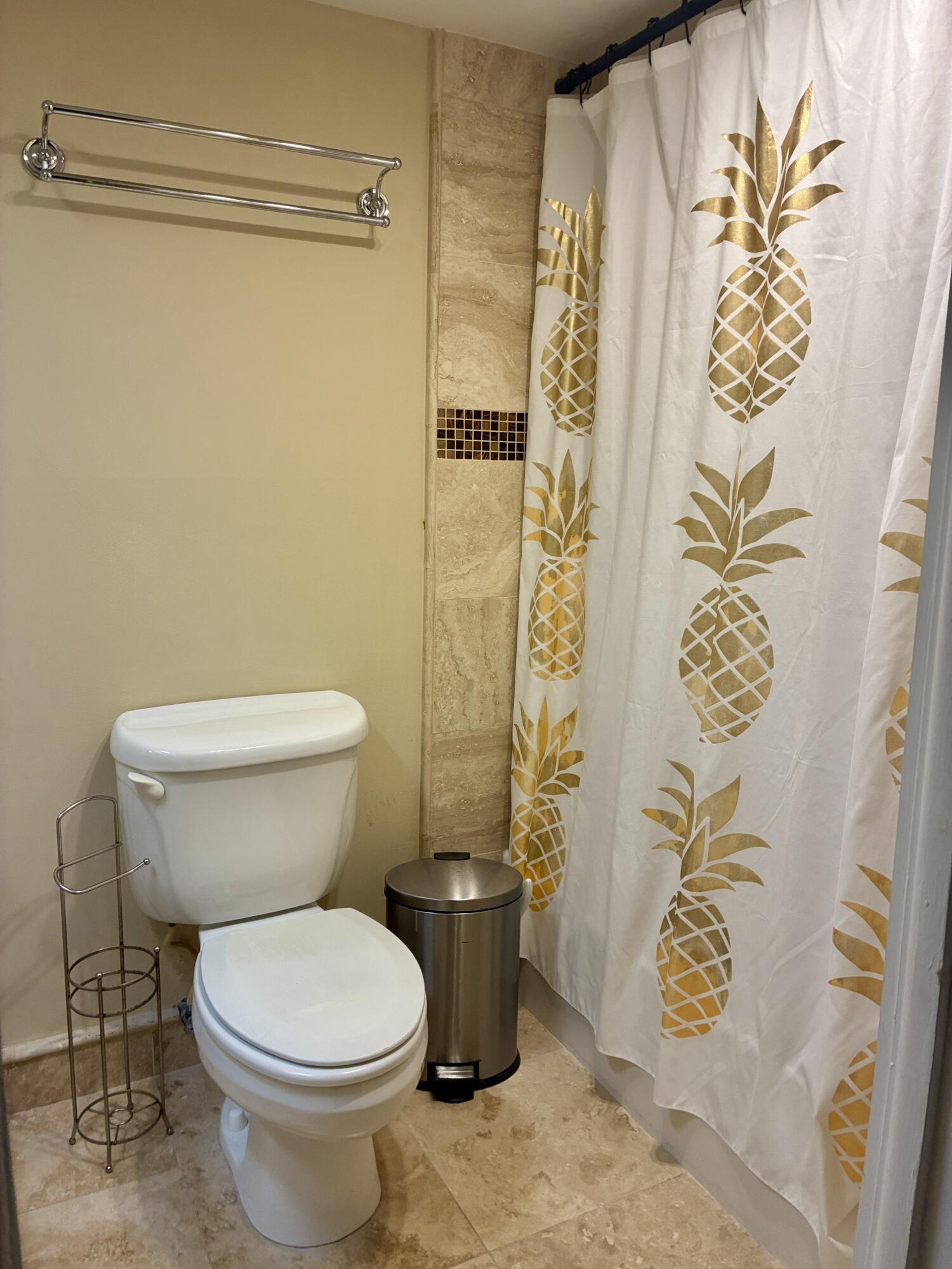 2691 South Course Drive, Unit 409 Pompano Beach, FL 33069 - Photo 13 of 22 a white toilet sitting next to a shower curtain