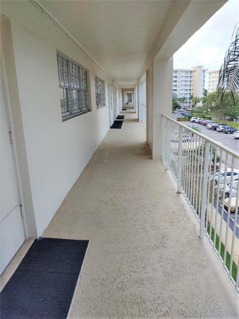 2691 South Course Drive, Unit 409 Pompano Beach, FL 33069 - Photo 17 of 22 a view of a balcony with city view
