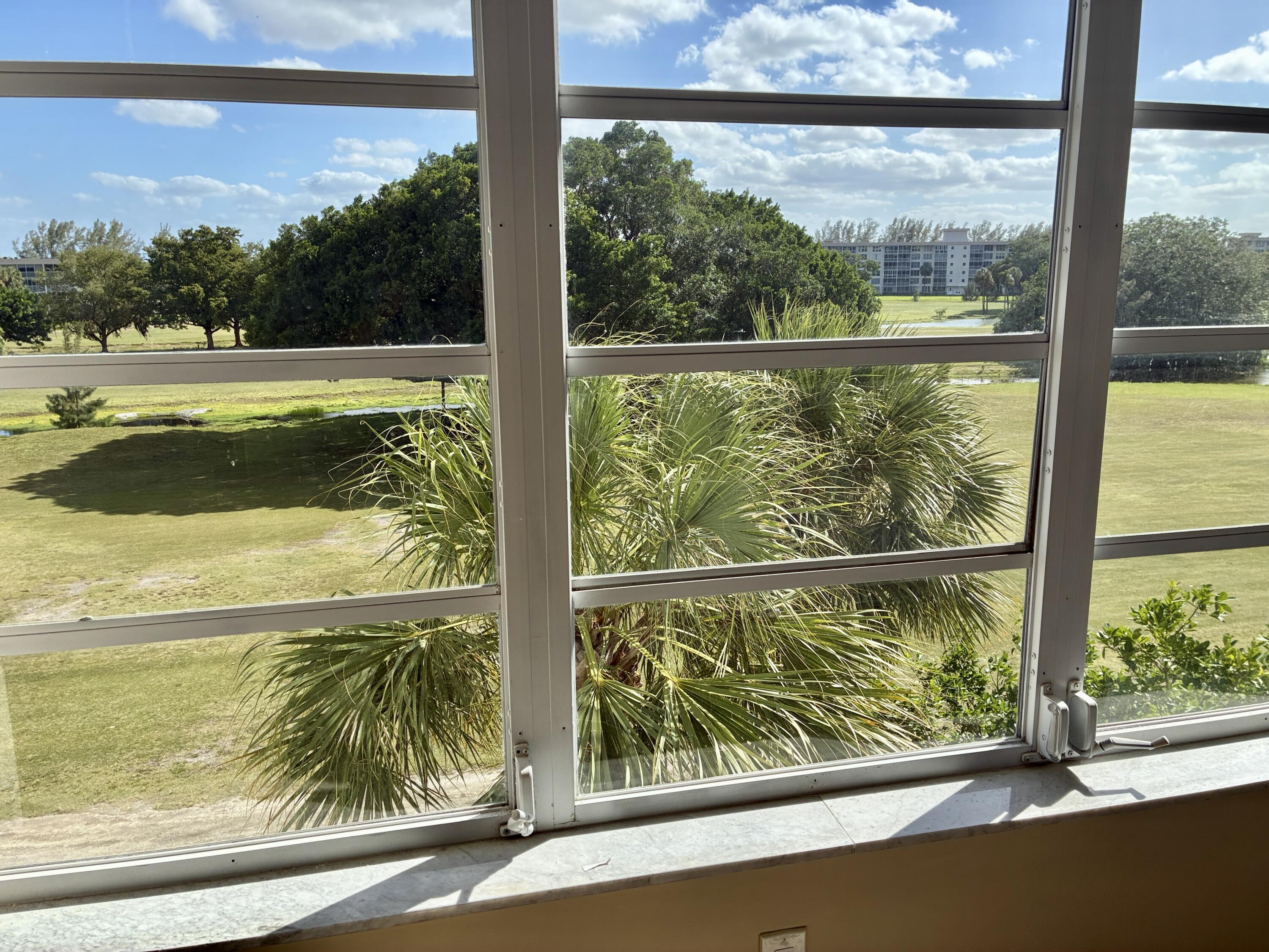 2691 South Course Drive, Unit 409 Pompano Beach, FL 33069 - Photo 19 of 22 a view of lake from a window