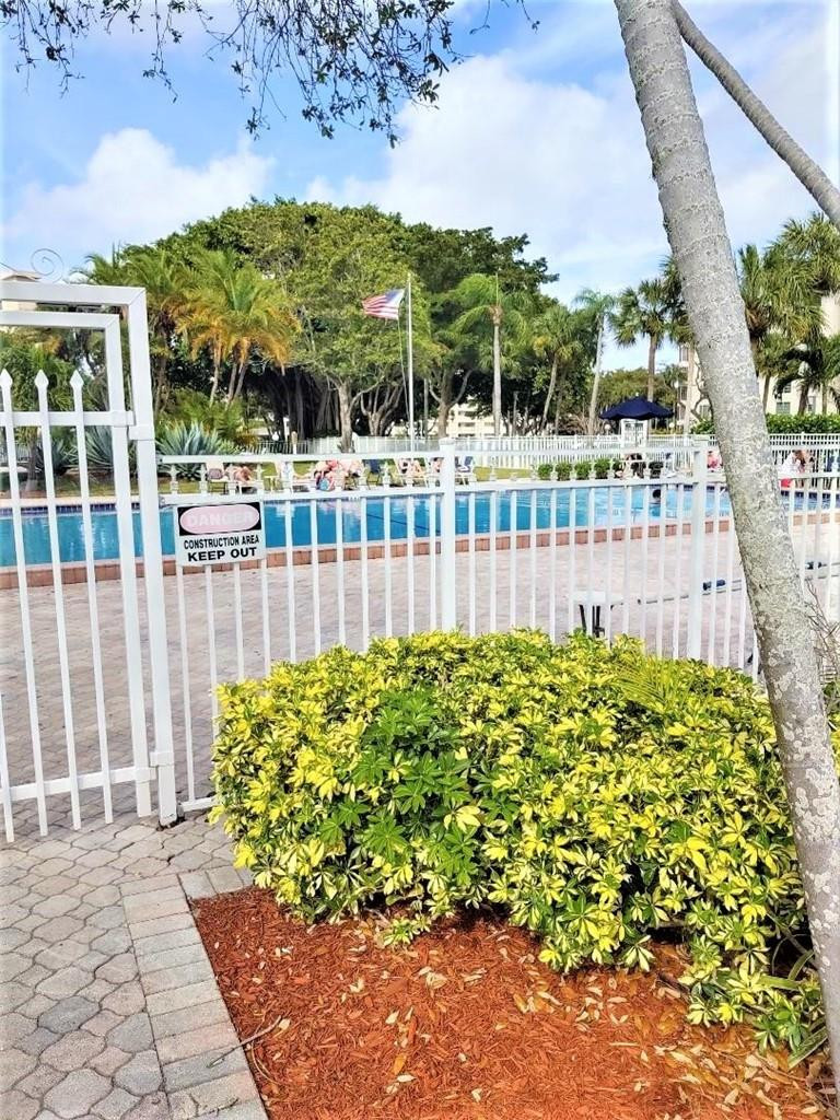 2691 South Course Drive, Unit 409 Pompano Beach, FL 33069 - Photo 22 of 22 a view of a garden with iron fence