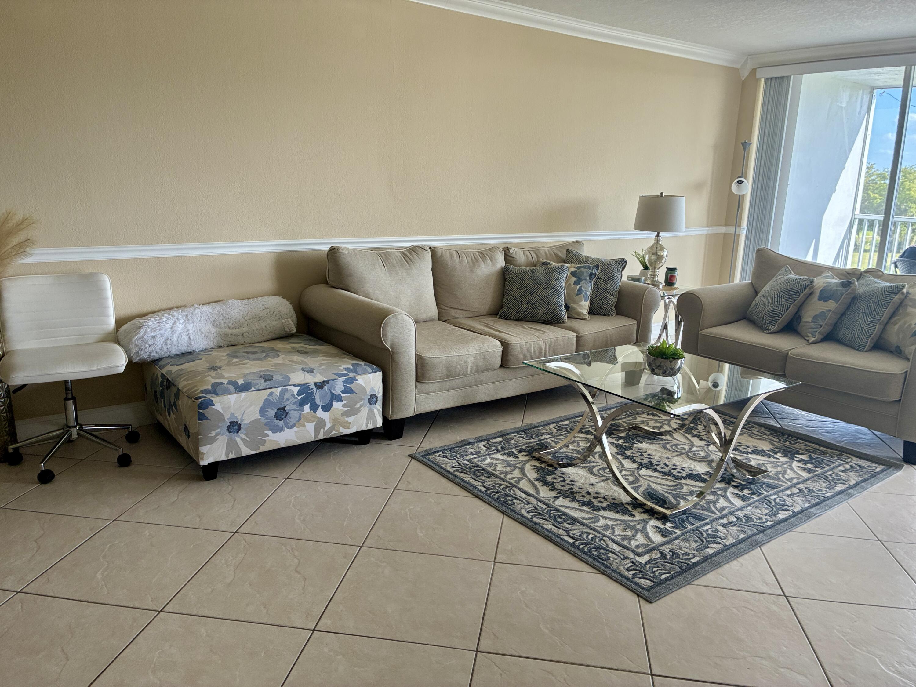 2691 South Course Drive, Unit 409 Pompano Beach, FL 33069 - Photo 3 of 22 a living room with furniture and a rug