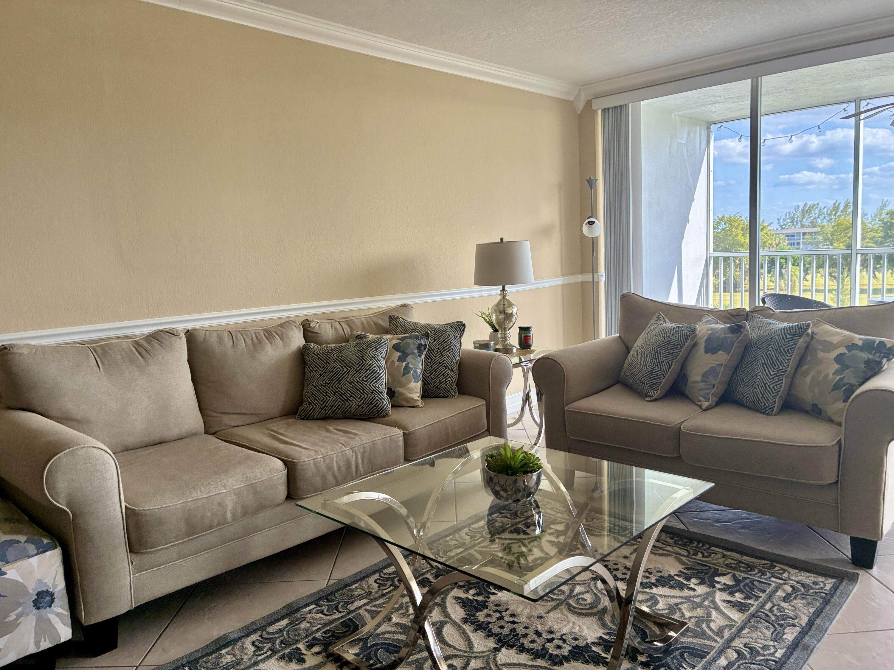 2691 South Course Drive, Unit 409 Pompano Beach, FL 33069 - Photo 4 of 22 a living room with furniture and a window