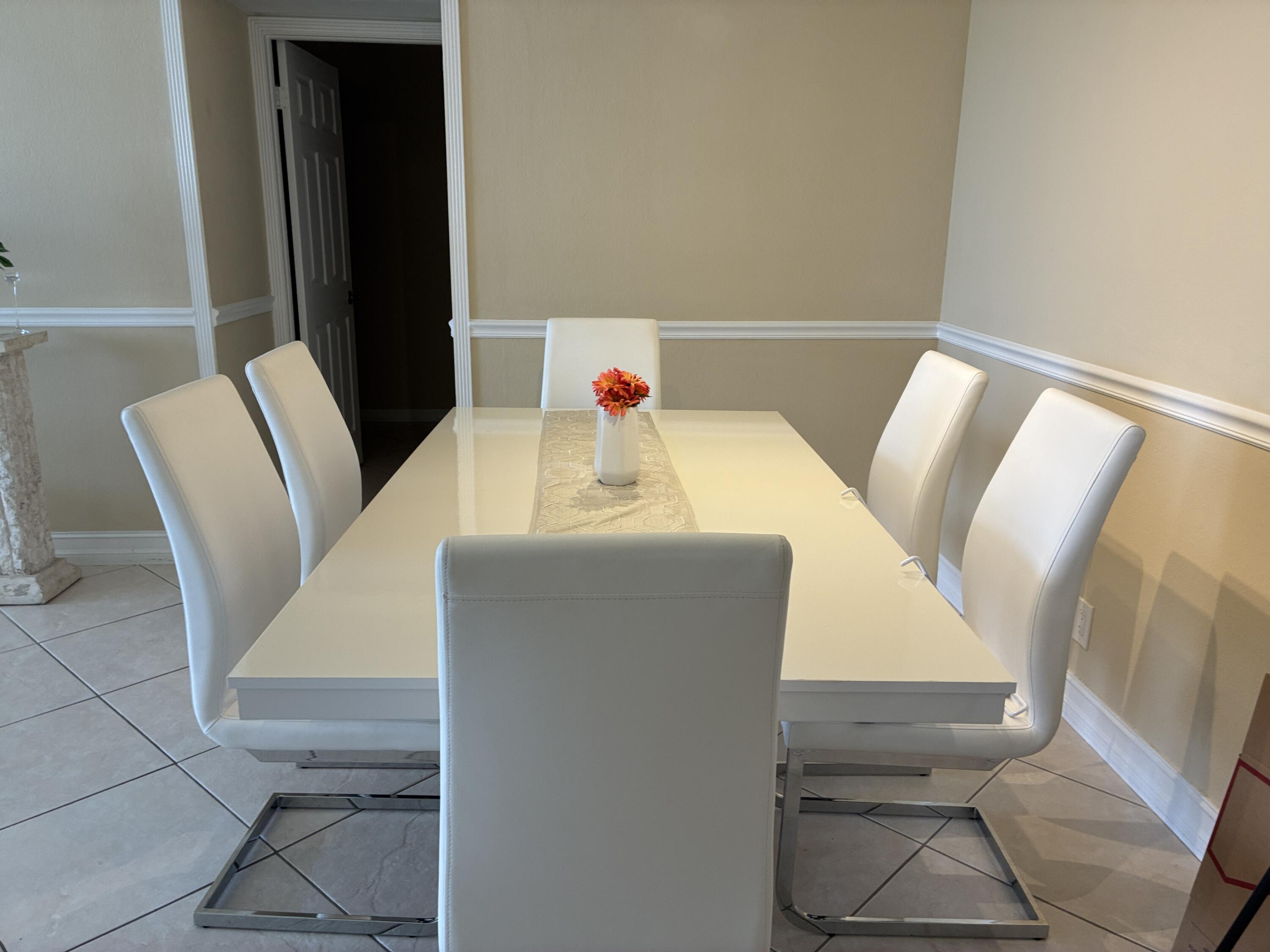 2691 South Course Drive, Unit 409 Pompano Beach, FL 33069 - Photo 7 of 22 a dining room with furniture and wooden floor