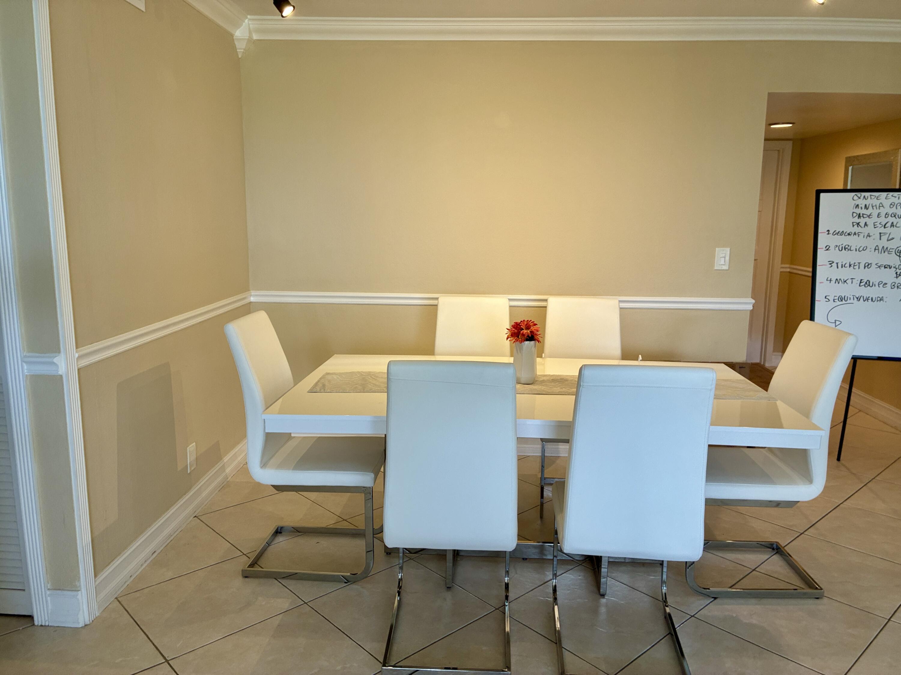 2691 South Course Drive, Unit 409 Pompano Beach, FL 33069 - Photo 8 of 22 a balcony with table and chairs