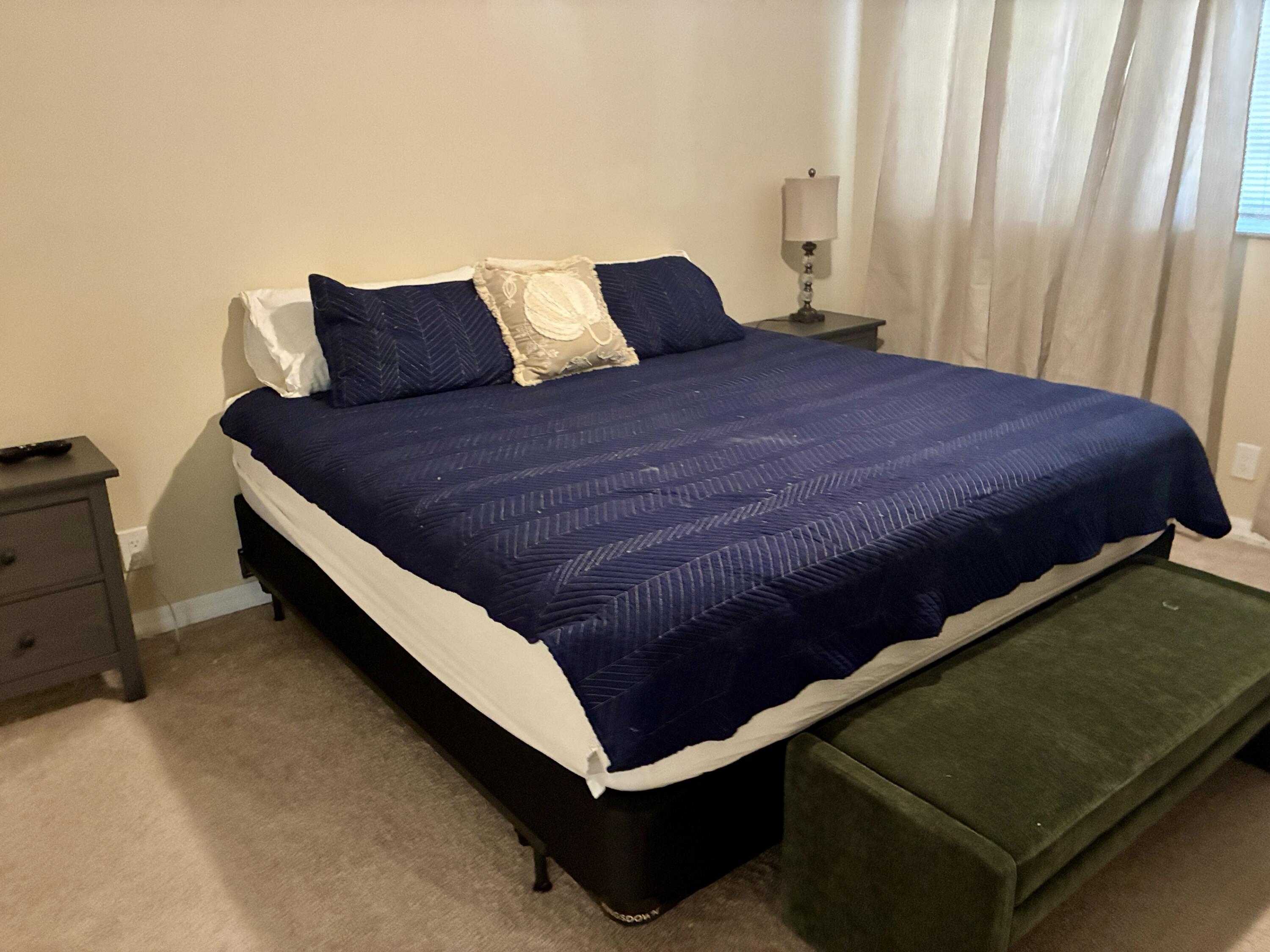 2691 South Course Drive, Unit 409 Pompano Beach, FL 33069 - Photo 9 of 22 a bed sitting in a bedroom next to a window