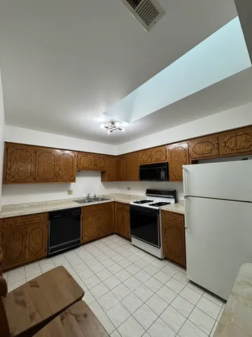 a kitchen with a cabinets and appliances