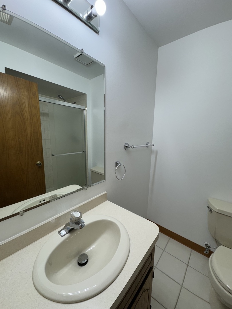 4535 Rumsey Avenue, Unit 3E Oak Lawn, IL 60453 - Photo 7 of 12 a bathroom with a sink and a mirror