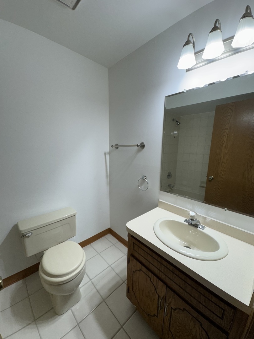 4535 Rumsey Avenue, Unit 3E Oak Lawn, IL 60453 - Photo 10 of 12 a bathroom with a sink toilet and vanity