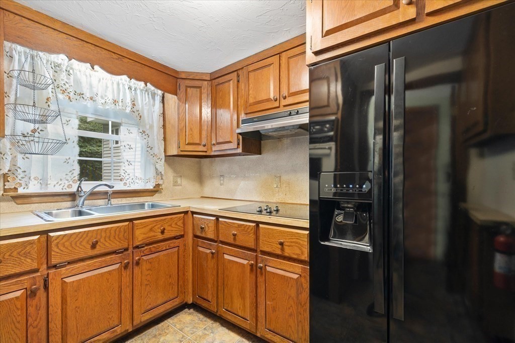 23 Mumford Road Sutton, MA 01590 - Photo 8 of 18 a kitchen with stainless steel appliances granite countertop a refrigerator and a sink