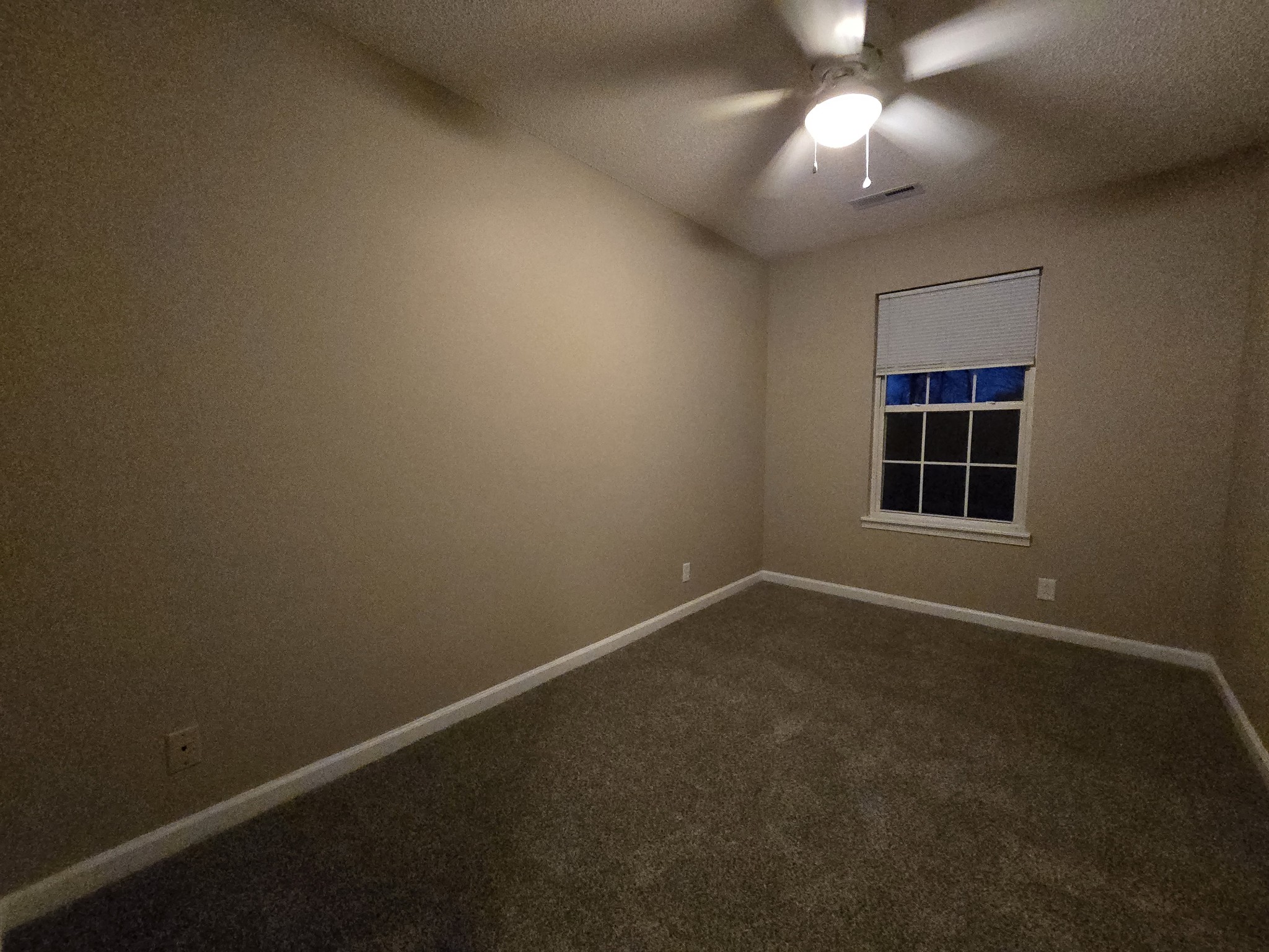 337 Bumpus Mill Road Oak Grove, KY 42262 - Photo 14 of 22 an empty room with a window and chandelier fan