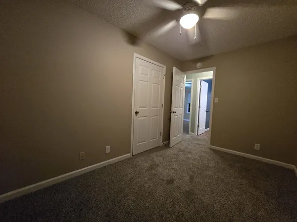 an empty room with a empty space and a ceiling fan
