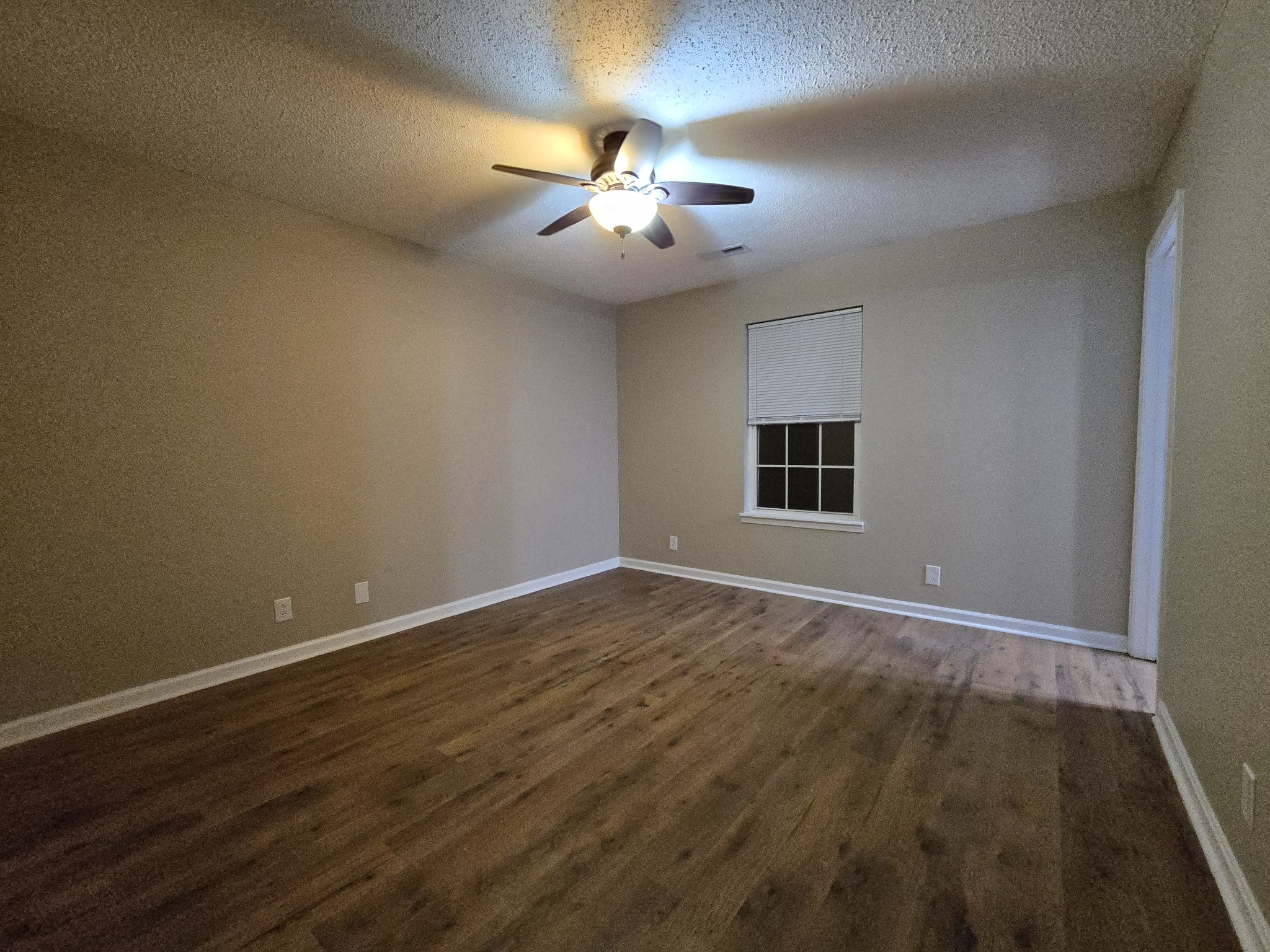 337 Bumpus Mill Road Oak Grove, KY 42262 - Photo 18 of 22 a view of an empty room with chandelier fan and wooden floor