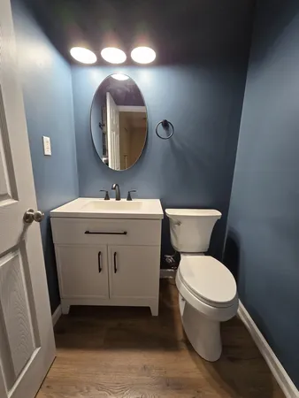 a bathroom with a toilet sink and mirror