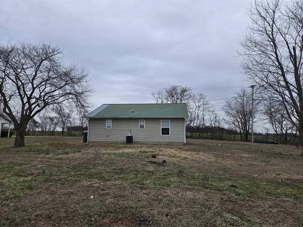 a front view of house with yard and trees