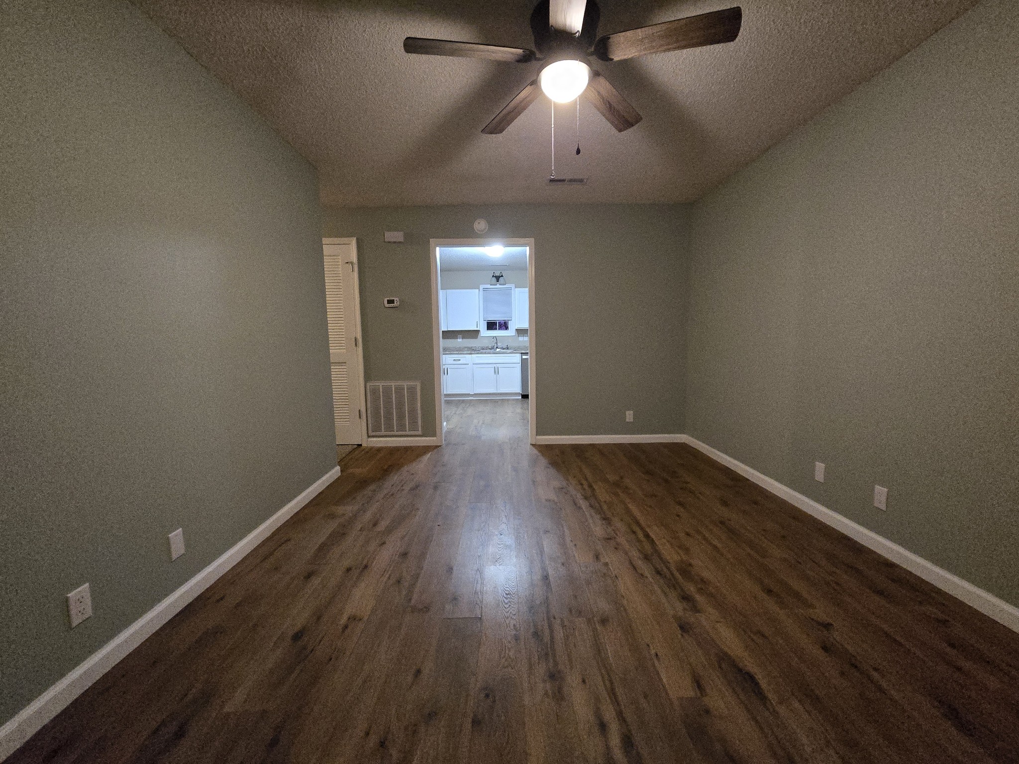 337 Bumpus Mill Road Oak Grove, KY 42262 - Photo 7 of 22 an empty room with wooden floor and windows