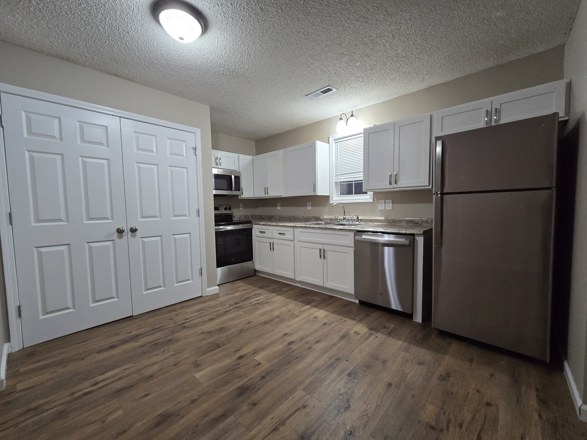 337 Bumpus Mill Road Oak Grove, KY 42262 - Photo 10 of 22 a kitchen with stainless steel appliances granite countertop a refrigerator sink and white cabinets