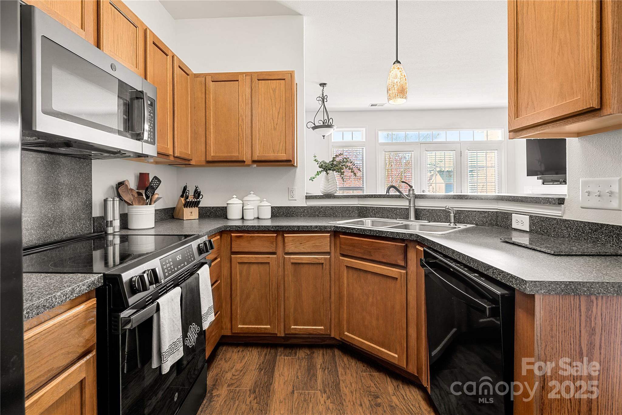 2443 Redmayne Lane Fort Mill, SC 29707 - Photo 8 of 43 a kitchen with stainless steel appliances granite countertop a sink a stove and a microwave