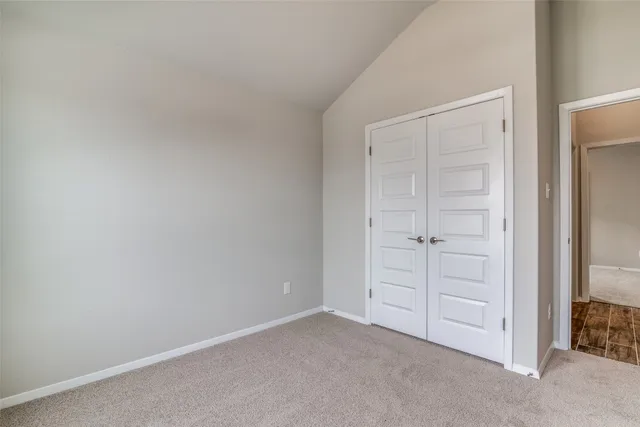 an empty room with closet area