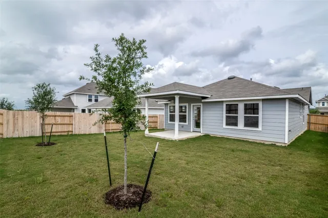 a backyard of a house with table and chairs